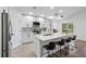 Modern kitchen featuring an island with quartz countertops, stainless steel appliances and wood flooring at 13409 Fawn Springs Dr, Tampa, FL 33626