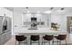 Modern kitchen with quartz countertops, stainless steel appliances, and a large island with seating at 13409 Fawn Springs Dr, Tampa, FL 33626