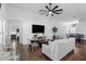 Open-concept living room featuring modern decor, hardwood flooring, and an elegant ceiling fan at 13409 Fawn Springs Dr, Tampa, FL 33626