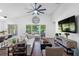 Bright, spacious living room with lake views, a comfortable sofa, and stylish decor accents at 13409 Fawn Springs Dr, Tampa, FL 33626
