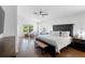Bright and open main bedroom with hardwood floors and a view of the outdoor scenery at 13409 Fawn Springs Dr, Tampa, FL 33626