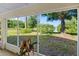 Relaxing screened patio view with lush greenery and a serene lake backdrop, offering tranquility at 13409 Fawn Springs Dr, Tampa, FL 33626