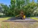 Community playground area with wooden play structure and slide at 13409 Fawn Springs Dr, Tampa, FL 33626