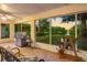 Charming screened patio overlooking a tranquil lake, complete with a grill for outdoor entertaining at 13409 Fawn Springs Dr, Tampa, FL 33626