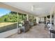 Lakeside screened patio with grill, offering serene outdoor relaxation and entertainment space at 13409 Fawn Springs Dr, Tampa, FL 33626