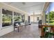 Relaxing screened porch offering tranquil views of the backyard and lake at 13409 Fawn Springs Dr, Tampa, FL 33626