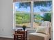 Cozy sitting area by a large window with tranquil lake views, perfect for reading and relaxation at 13409 Fawn Springs Dr, Tampa, FL 33626