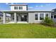 Exterior view shows the home's covered patio, lawn, and landscaping at 1586 Running Tide Pl, Sarasota, FL 34240