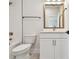 Modern bathroom with a tub, white subway tile and vanity with gold hardware at 1586 Running Tide Pl, Sarasota, FL 34240