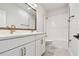 Elegant bathroom with double vanity, white cabinets, and a shower-tub combination at 1586 Running Tide Pl, Sarasota, FL 34240