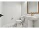 Stylish powder room featuring a pedestal sink, modern fixtures, and a tiled floor at 1586 Running Tide Pl, Sarasota, FL 34240