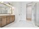 Beautiful bathroom with dual vanity, walk-in shower, and seamless access to a large walk-in closet at 1586 Running Tide Pl, Sarasota, FL 34240