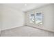 Cozy bedroom with neutral carpet, two windows offering natural light and neighborhood views at 1586 Running Tide Pl, Sarasota, FL 34240