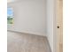 Bright bedroom with carpet, a window with neighborhood views, and an attached bath at 1586 Running Tide Pl, Sarasota, FL 34240