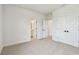 Spacious bedroom featuring neutral carpet, double closets, and bathroom access at 1586 Running Tide Pl, Sarasota, FL 34240