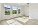 Light-filled bedroom boasts hardwood floors, three large windows, and neutral finishes at 1586 Running Tide Pl, Sarasota, FL 34240