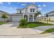 Charming two-story home with manicured lawn, lovely landscaping and a welcoming front porch at 1586 Running Tide Pl, Sarasota, FL 34240