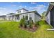 Exterior view shows the home's covered patio, lawn, and landscaping at 1586 Running Tide Pl, Sarasota, FL 34240