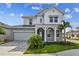 Charming two-story home with manicured lawn, lovely landscaping and a welcoming front porch at 1586 Running Tide Pl, Sarasota, FL 34240