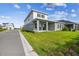 Exterior shot reveals a well-manicured lawn and covered patio at 1586 Running Tide Pl, Sarasota, FL 34240