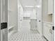 Hallway features patterned tile flooring, white trim, and a built-in bench at 1586 Running Tide Pl, Sarasota, FL 34240