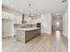 Modern kitchen boasts stainless steel appliances, a large center island, and pendant lighting at 1586 Running Tide Pl, Sarasota, FL 34240