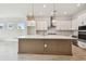 Bright kitchen with large island, pendant lighting, modern appliances, and stylish white cabinets at 1586 Running Tide Pl, Sarasota, FL 34240