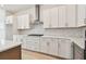 Kitchen featuring white cabinets, marble backsplash, stainless appliances and gas cooktop at 1586 Running Tide Pl, Sarasota, FL 34240