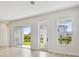 Living room with large windows and sliding glass doors showcasing an outdoor view at 1586 Running Tide Pl, Sarasota, FL 34240