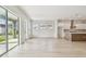 Open floor plan: living room with kitchen view, sliding doors to the outside patio at 1586 Running Tide Pl, Sarasota, FL 34240