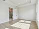 Bright bedroom with a tray ceiling and doorway leading to the en-suite bathroom at 1586 Running Tide Pl, Sarasota, FL 34240