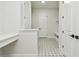 Mudroom with star pattern tile, built-in bench, and access to the garage at 1586 Running Tide Pl, Sarasota, FL 34240