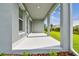 Covered patio offers ample space for outdoor seating with a backyard view at 1586 Running Tide Pl, Sarasota, FL 34240