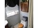 Cozy bathroom featuring a toilet, cabinet, and window at 1663 Cambridge Dr, Clearwater, FL 33756