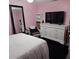 Pink bedroom with white furnishings and a dark carpet at 1663 Cambridge Dr, Clearwater, FL 33756