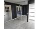 A bedroom is visible featuring mirrored walls, and white tile flooring at 1663 Cambridge Dr, Clearwater, FL 33756