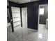 This bedroom features white tile flooring, built in shelving, and black walls at 1663 Cambridge Dr, Clearwater, FL 33756