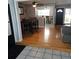 Hardwood floor in the dining area with ceiling fan and pass through to the kitchen at 1663 Cambridge Dr, Clearwater, FL 33756