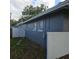 Exterior view of a gray single story home with white trim, windows, and a white brick accent wall at 1663 Cambridge Dr, Clearwater, FL 33756