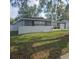Charming single story home with white painted brick wall, and well-manicured front lawn at 1663 Cambridge Dr, Clearwater, FL 33756