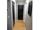 Hallway featuring beautiful wood floors and a black interior door at 1663 Cambridge Dr, Clearwater, FL 33756