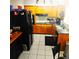 Charming kitchen with wood cabinetry, black appliances, and tile flooring at 1663 Cambridge Dr, Clearwater, FL 33756
