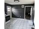 An open-concept kitchen with gray walls, white tile floors and white appliances at 1663 Cambridge Dr, Clearwater, FL 33756