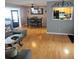 Cozy living room featuring hardwood floors, dining area and pass-through window to the kitchen at 1663 Cambridge Dr, Clearwater, FL 33756