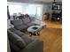 Open-concept living room with hardwood floors, gray paint, a dining area, and modern furnishings at 1663 Cambridge Dr, Clearwater, FL 33756