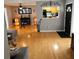 Cozy living room featuring hardwood floors and an open view into the kitchen at 1663 Cambridge Dr, Clearwater, FL 33756