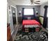 Comfortable main bedroom with a red bedspread and elegant decor at 1663 Cambridge Dr, Clearwater, FL 33756