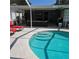A stunning outdoor pool with steps and a covered patio area to relax and unwind at 1663 Cambridge Dr, Clearwater, FL 33756