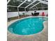 An outdoor pool featuring a patio area with table and chairs, and lounge chairs for relaxation at 1663 Cambridge Dr, Clearwater, FL 33756
