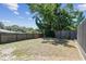 Spacious backyard with mature trees and fence, providing privacy and shade for outdoor enjoyment at 1666 Pine Pl, Clearwater, FL 33755